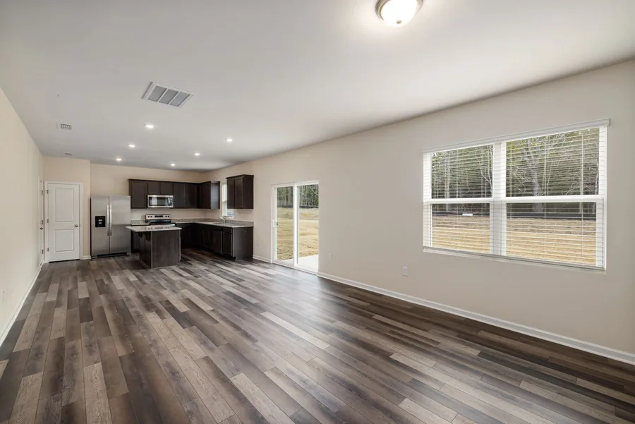 Wood-toned flooring connecting a kitchen and living space, shown as interior inspiration.